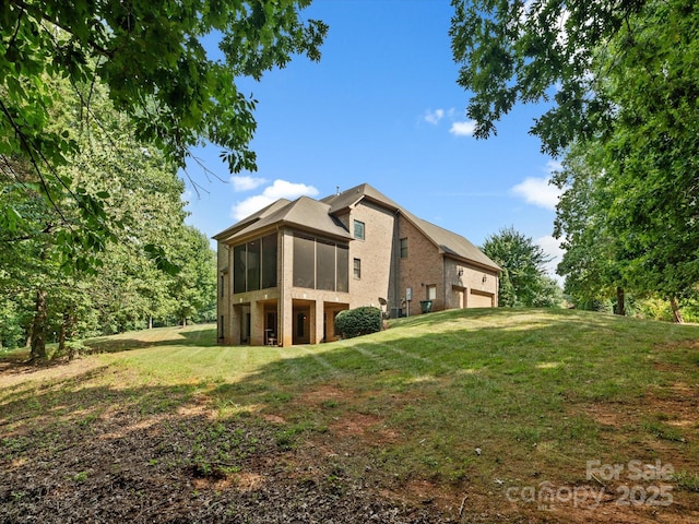 8407 Rolling Fields Rd, Mint Hill, NC 28227 - rear view of house with a sunroom, a yard, and brick siding