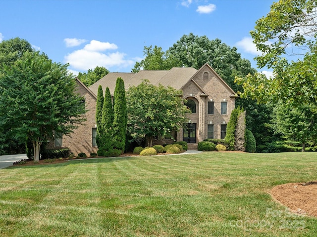 8407 Rolling Fields Rd, Mint Hill, NC 28227 - view of front facade with brick siding, a front lawn, and french doors