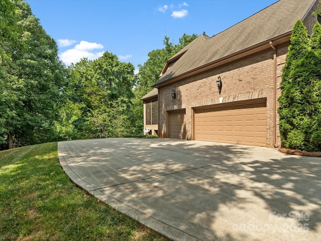 8407 Rolling Fields Rd, Mint Hill, NC 28227 - view of home's exterior featuring brick siding, an attached garage, driveway, and roof with shingles
