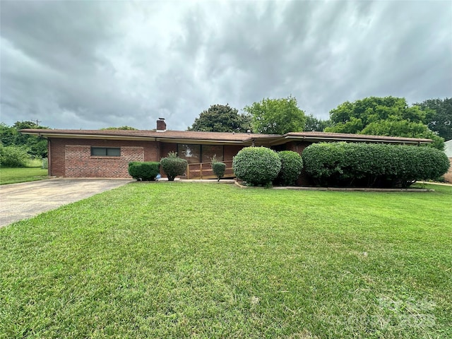 2128 Senior Dr, Charlotte, NC 28216 - ranch-style home with a front yard, a chimney, and brick siding