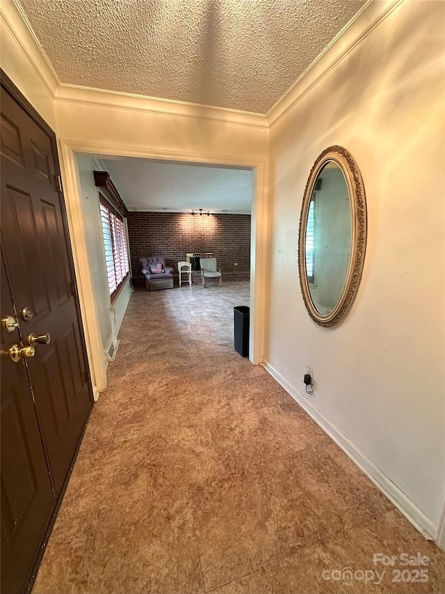 2128 Senior Dr, Charlotte, NC 28216 - corridor with crown molding, a textured ceiling, carpet, and brick wall