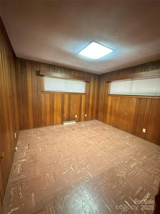 2128 Senior Dr, Charlotte, NC 28216 - spare room with baseboard heating and wooden walls