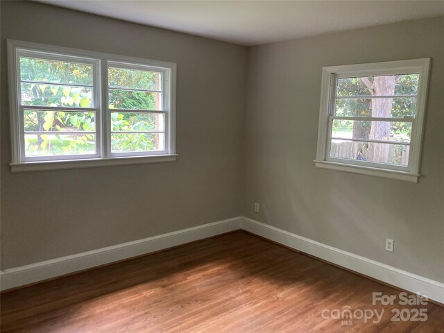 1162 Brighton Pl, Charlotte, NC 28205 - unfurnished room featuring plenty of natural light and wood finished floors