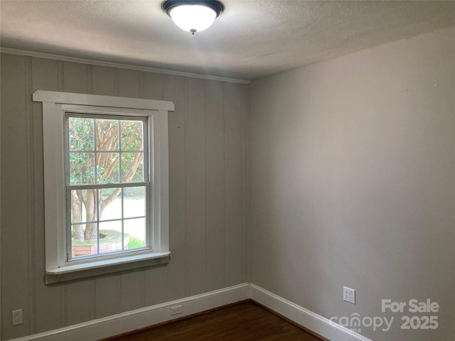 1162 Brighton Pl, Charlotte, NC 28205 - empty room with dark wood-style floors, healthy amount of natural light, and a textured ceiling