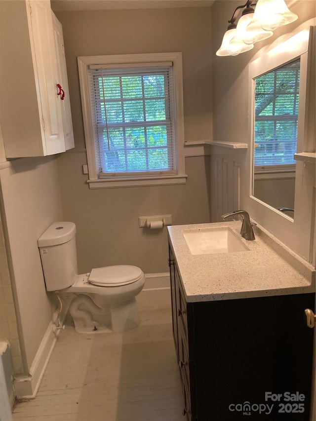1162 Brighton Pl, Charlotte, NC 28205 - bathroom with vanity, plenty of natural light, and a chandelier