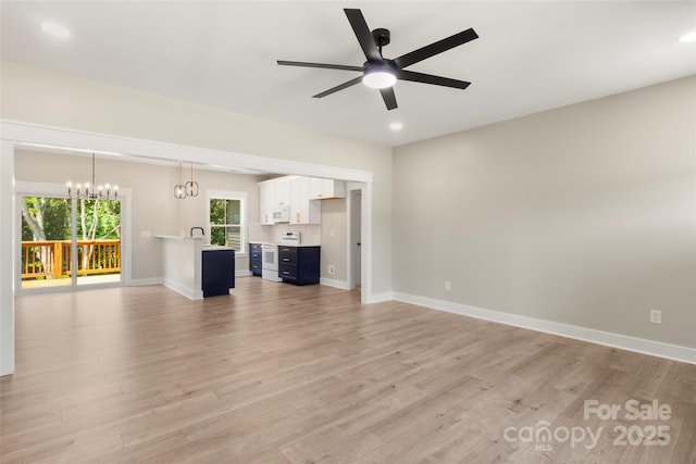 299 Collingswood Dr, Concord, NC 28027 - unfurnished living room with light wood finished floors, ceiling fan, a chandelier, and recessed lighting