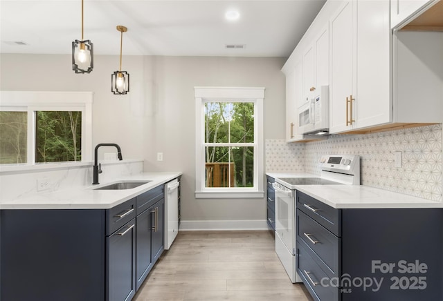 299 Collingswood Dr, Concord, NC 28027 - kitchen featuring white appliances, light wood finished floors, tasteful backsplash, and white cabinetry