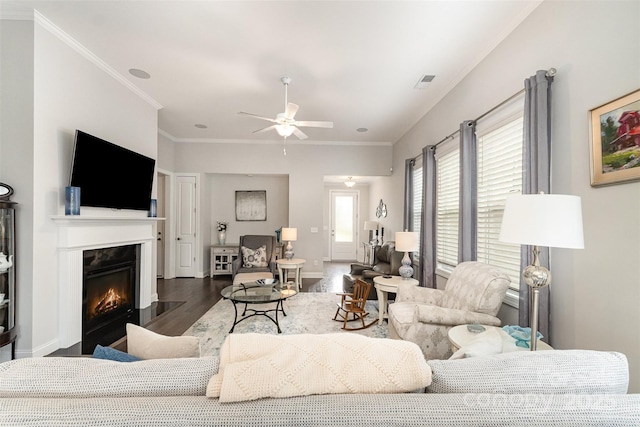 7025 Overjoyed Xing, Charlotte, NC 28215 - living room featuring wood finished floors, a ceiling fan, a warm lit fireplace, and ornamental molding