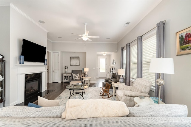 7025 Overjoyed Xing, Charlotte, NC 28215 - living area featuring wood finished floors, ceiling fan, a fireplace with flush hearth, and ornamental molding