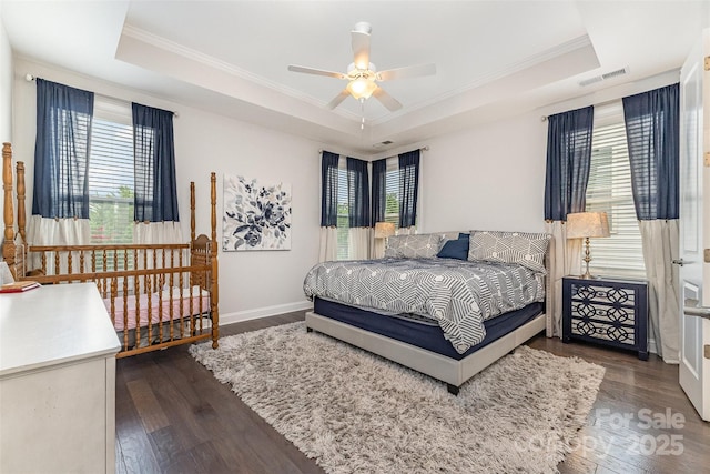 7025 Overjoyed Xing, Charlotte, NC 28215 - bedroom featuring a tray ceiling, ornamental molding, wood finished floors, and ceiling fan