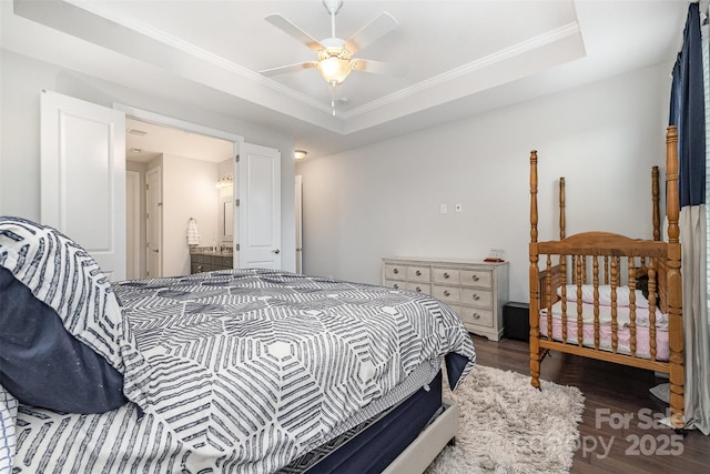 7025 Overjoyed Xing, Charlotte, NC 28215 - bedroom featuring wood finished floors, ornamental molding, a tray ceiling, a ceiling fan, and ensuite bath