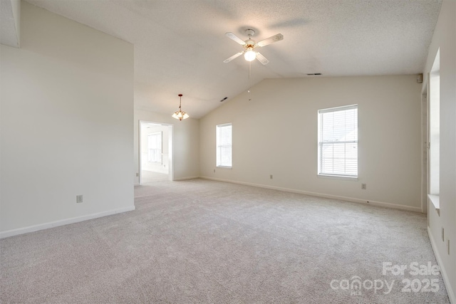 659 Primrose Ln NW, Concord, NC 28027 - spare room with light carpet, ceiling fan, lofted ceiling, a chandelier, and a textured ceiling
