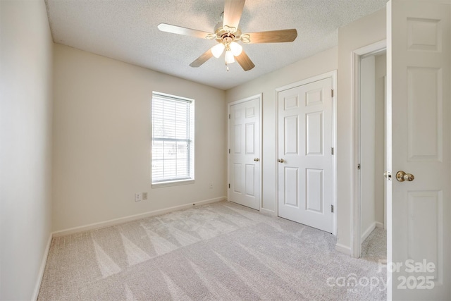 659 Primrose Ln NW, Concord, NC 28027 - unfurnished bedroom with light carpet, a textured ceiling, and ceiling fan