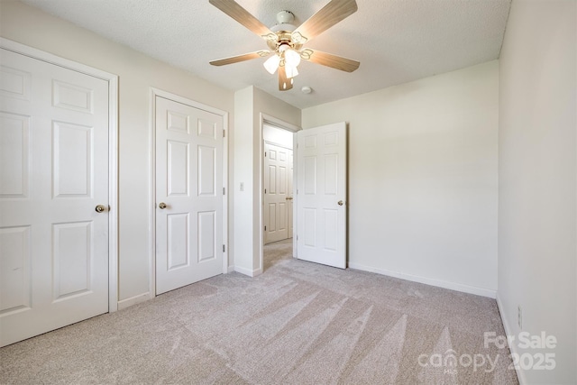 659 Primrose Ln NW, Concord, NC 28027 - unfurnished bedroom with carpet, a textured ceiling, and a ceiling fan