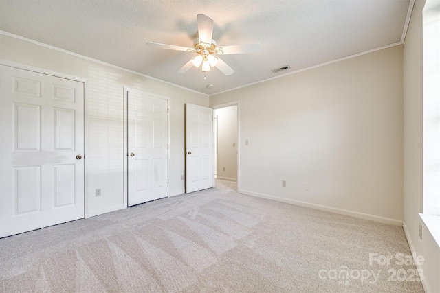 659 Primrose Ln NW, Concord, NC 28027 - unfurnished bedroom with carpet floors, crown molding, a textured ceiling, a ceiling fan, and a closet
