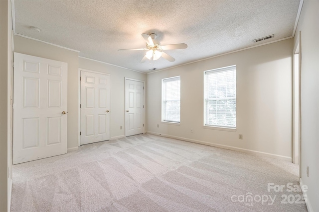 659 Primrose Ln NW, Concord, NC 28027 - unfurnished bedroom featuring carpet flooring, a textured ceiling, ornamental molding, and a ceiling fan