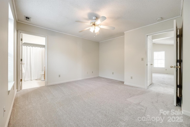 659 Primrose Ln NW, Concord, NC 28027 - spare room with a ceiling fan, light carpet, a textured ceiling, crown molding, and a smoke detector