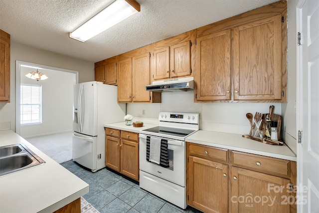 659 Primrose Ln NW, Concord, NC 28027 - kitchen featuring white appliances, under cabinet range hood, light countertops, a textured ceiling, and brown cabinets