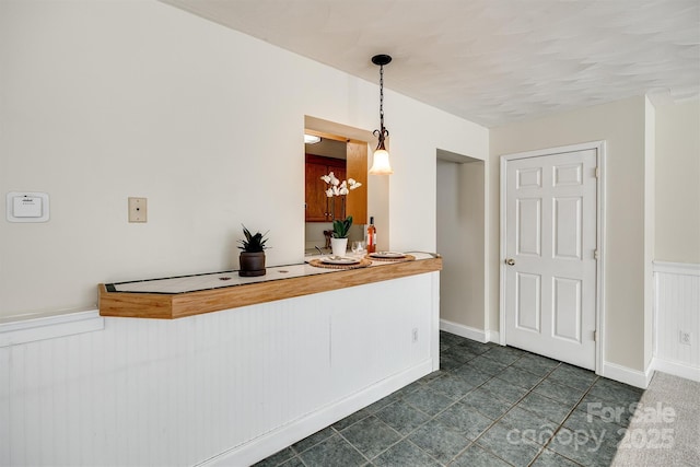 659 Primrose Ln NW, Concord, NC 28027 - kitchen featuring a wainscoted wall and decorative light fixtures