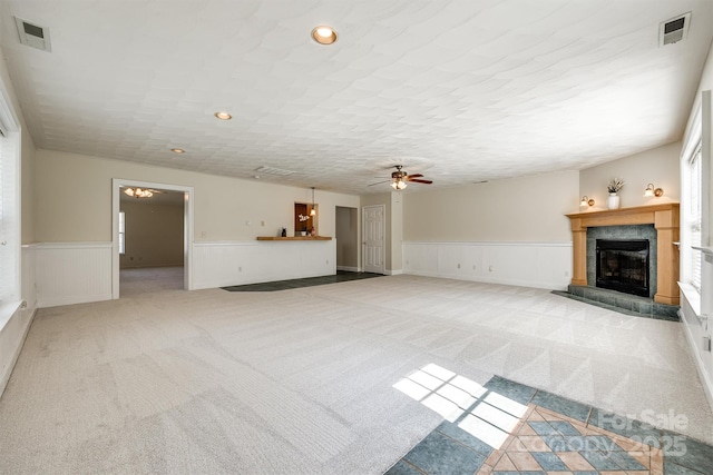659 Primrose Ln NW, Concord, NC 28027 - unfurnished living room featuring carpet floors, wainscoting, ceiling fan, a tile fireplace, and recessed lighting