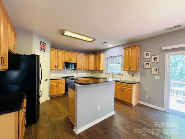 3236 Wicklow Ln, Clover, SC 29710 - kitchen featuring stainless steel range, black microwave, freestanding refrigerator, dark wood finished floors, and recessed lighting