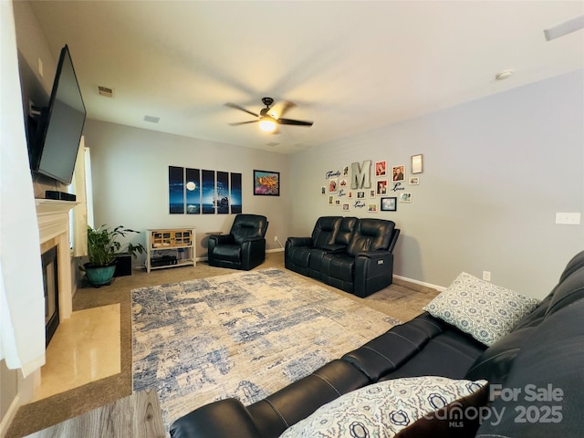3236 Wicklow Ln, Clover, SC 29710 - living room featuring a ceiling fan, carpet flooring, and a glass covered fireplace