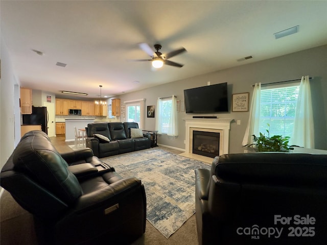 3236 Wicklow Ln, Clover, SC 29710 - living area featuring ceiling fan, a fireplace with flush hearth, and light carpet