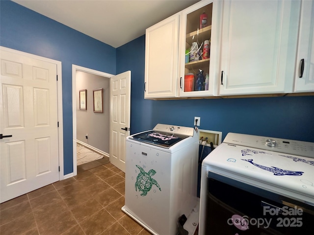 3236 Wicklow Ln, Clover, SC 29710 - laundry area with washer and dryer, cabinet space, and dark tile patterned flooring