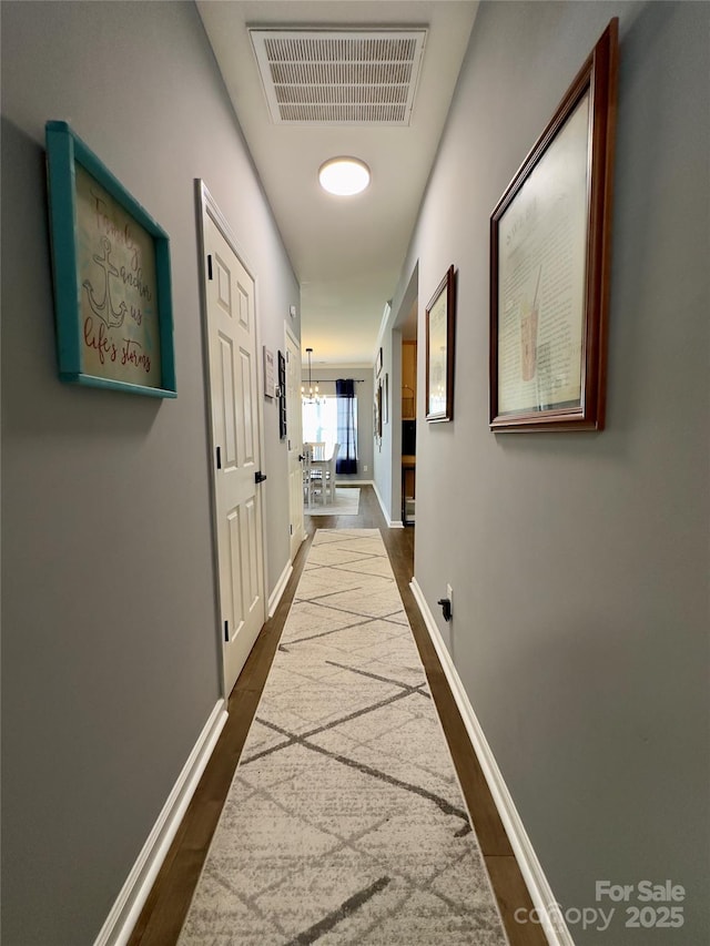 3236 Wicklow Ln, Clover, SC 29710 - corridor with dark wood-type flooring and a chandelier