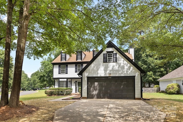 6907 Spandril Ln, Charlotte, NC 28215 - view of front facade with concrete driveway, a garage, and a chimney