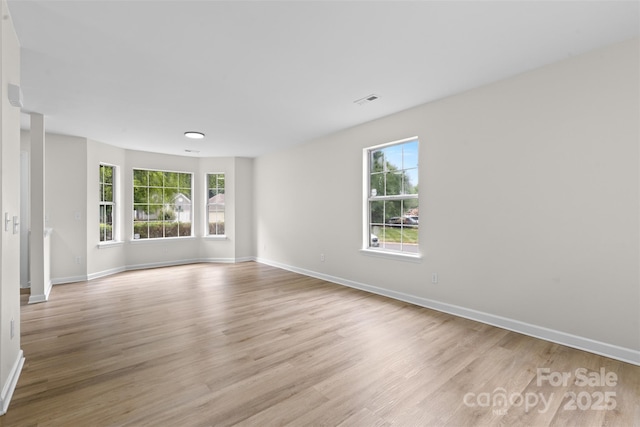 6907 Spandril Ln, Charlotte, NC 28215 - empty room with healthy amount of natural light and light wood-style floors