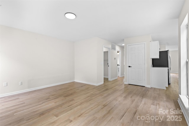 6907 Spandril Ln, Charlotte, NC 28215 - spare room with light wood-style flooring and baseboards