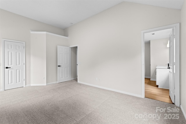6907 Spandril Ln, Charlotte, NC 28215 - unfurnished bedroom with carpet floors and vaulted ceiling