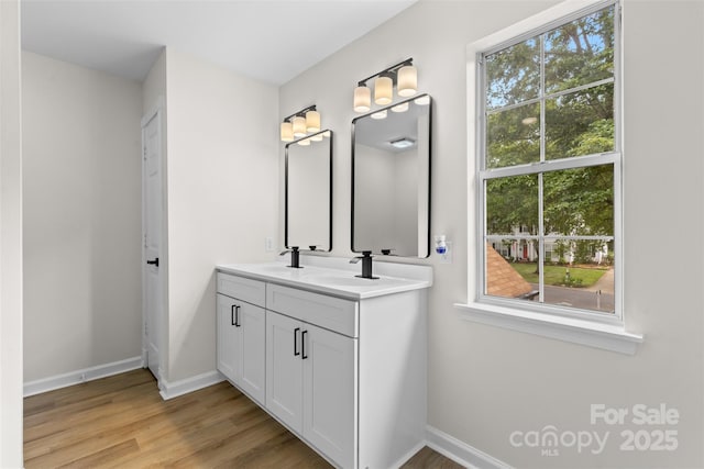6907 Spandril Ln, Charlotte, NC 28215 - full bathroom featuring double vanity and wood finished floors