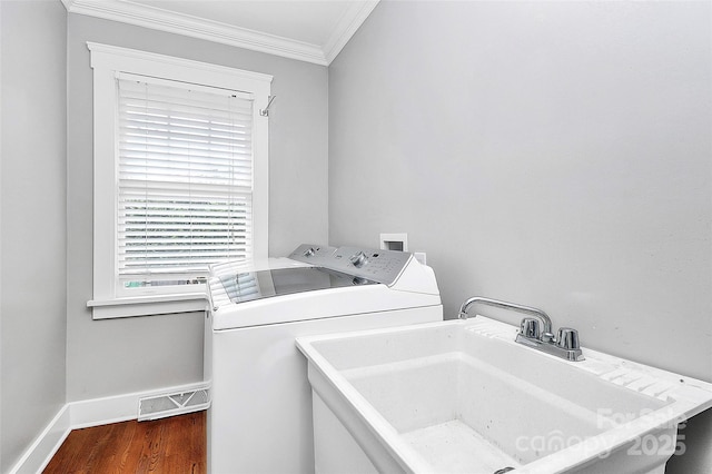 427 Lansdowne Rd, Charlotte, NC 28270 - laundry room featuring washing machine and clothes dryer, crown molding, and wood finished floors