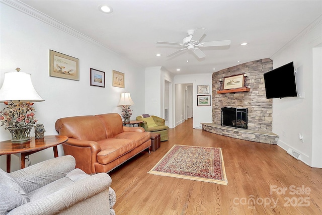 427 Lansdowne Rd, Charlotte, NC 28270 - living room with ceiling fan, wood finished floors, a stone fireplace, recessed lighting, and ornamental molding