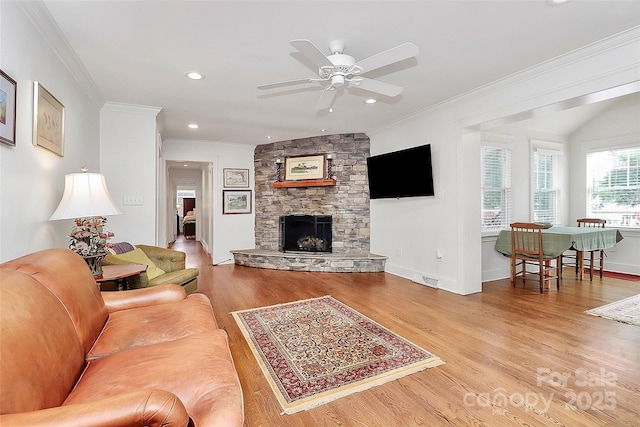 427 Lansdowne Rd, Charlotte, NC 28270 - living room featuring wood finished floors, crown molding, ceiling fan, a stone fireplace, and recessed lighting
