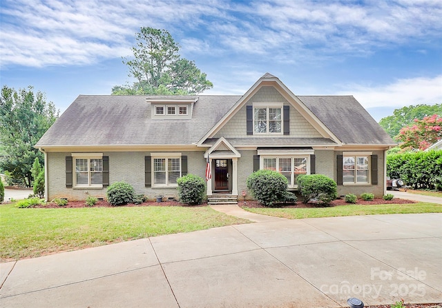 427 Lansdowne Rd, Charlotte, NC 28270 - view of front facade featuring a front yard, brick siding, and a shingled roof