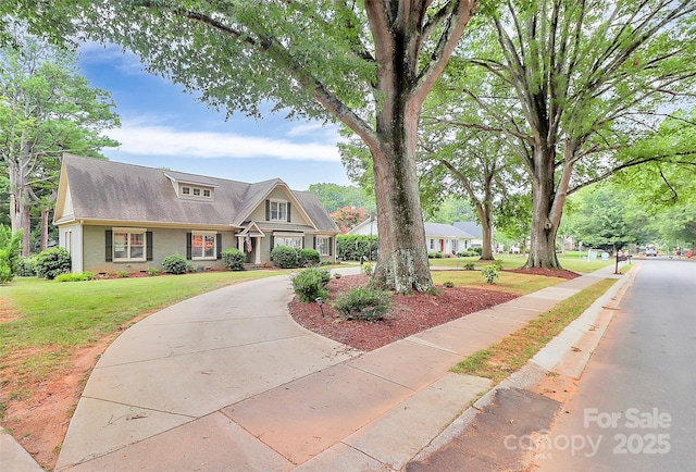 427 Lansdowne Rd, Charlotte, NC 28270 - view of front facade with a front yard, concrete driveway, and brick siding