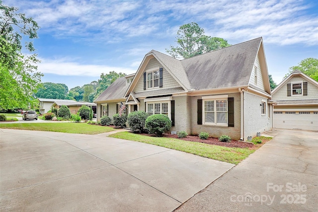 427 Lansdowne Rd, Charlotte, NC 28270 - view of front facade with brick siding, driveway, a front lawn, a shingled roof, and a garage
