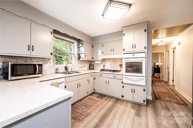 464 23rd Avenue Dr NE, Hickory, NC 28601 - kitchen with stainless steel appliances, a warming drawer, light countertops, light wood-type flooring, and ornamental molding