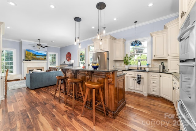 200 Galey Rdg, Cramerton, NC 28032 - kitchen featuring appliances with stainless steel finishes, open floor plan, dark wood-style floors, dark countertops, and crown molding