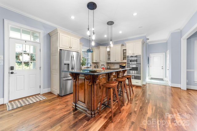 200 Galey Rdg, Cramerton, NC 28032 - kitchen with stainless steel appliances, a warming drawer, plenty of natural light, a kitchen breakfast bar, and crown molding