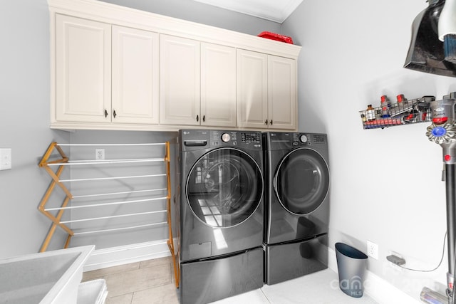 200 Galey Rdg, Cramerton, NC 28032 - laundry room featuring washing machine and dryer, cabinet space, light tile patterned floors, and ornamental molding