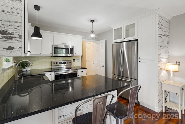 181 Farington Cir, Fletcher, NC 28732 - kitchen featuring appliances with stainless steel finishes, white cabinets, tasteful backsplash, glass insert cabinets, and a peninsula