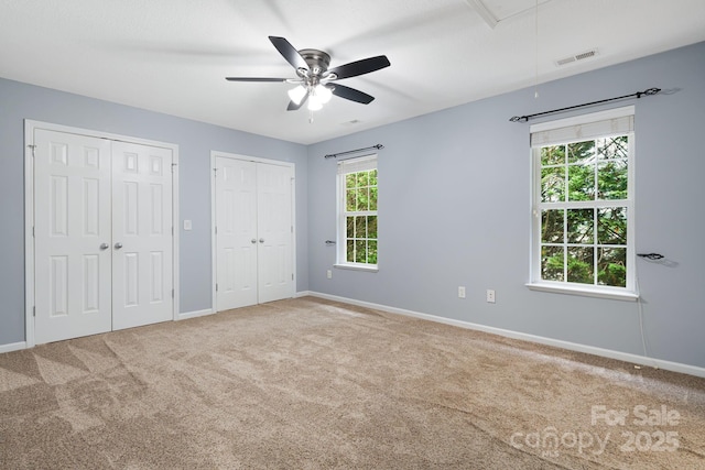 181 Farington Cir, Fletcher, NC 28732 - unfurnished bedroom with attic access, multiple closets, carpet, and a ceiling fan