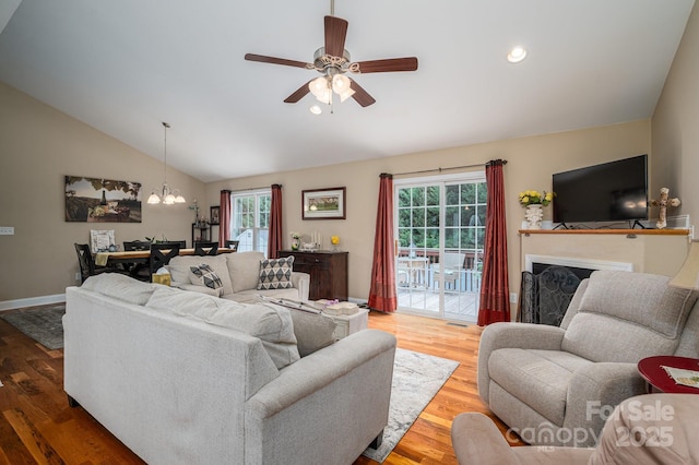 515 E Carpenter St, Maiden, NC 28650 - living room with a ceiling fan, a chandelier, vaulted ceiling, wood finished floors, and a fireplace