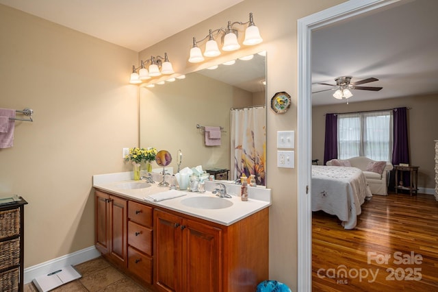 515 E Carpenter St, Maiden, NC 28650 - ensuite bathroom with double vanity, ceiling fan, and wood finished floors