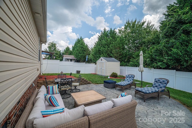515 E Carpenter St, Maiden, NC 28650 - fenced backyard with an outdoor hangout area, a patio, a storage unit, and outdoor dining space