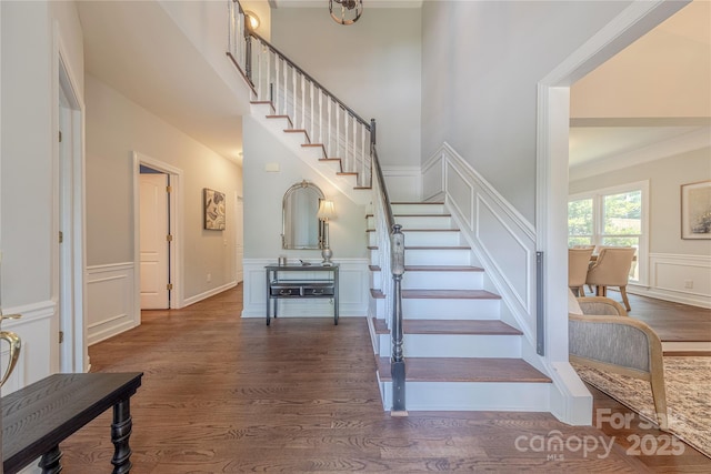2836 Providence Spring Ln, Charlotte, NC 28270 - staircase with a decorative wall, wood finished floors, and wainscoting